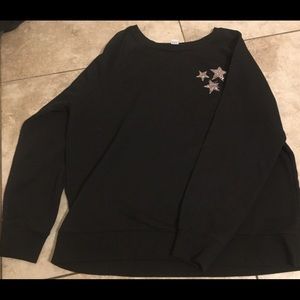 Black sweatshirt with three glittery stars on the left side